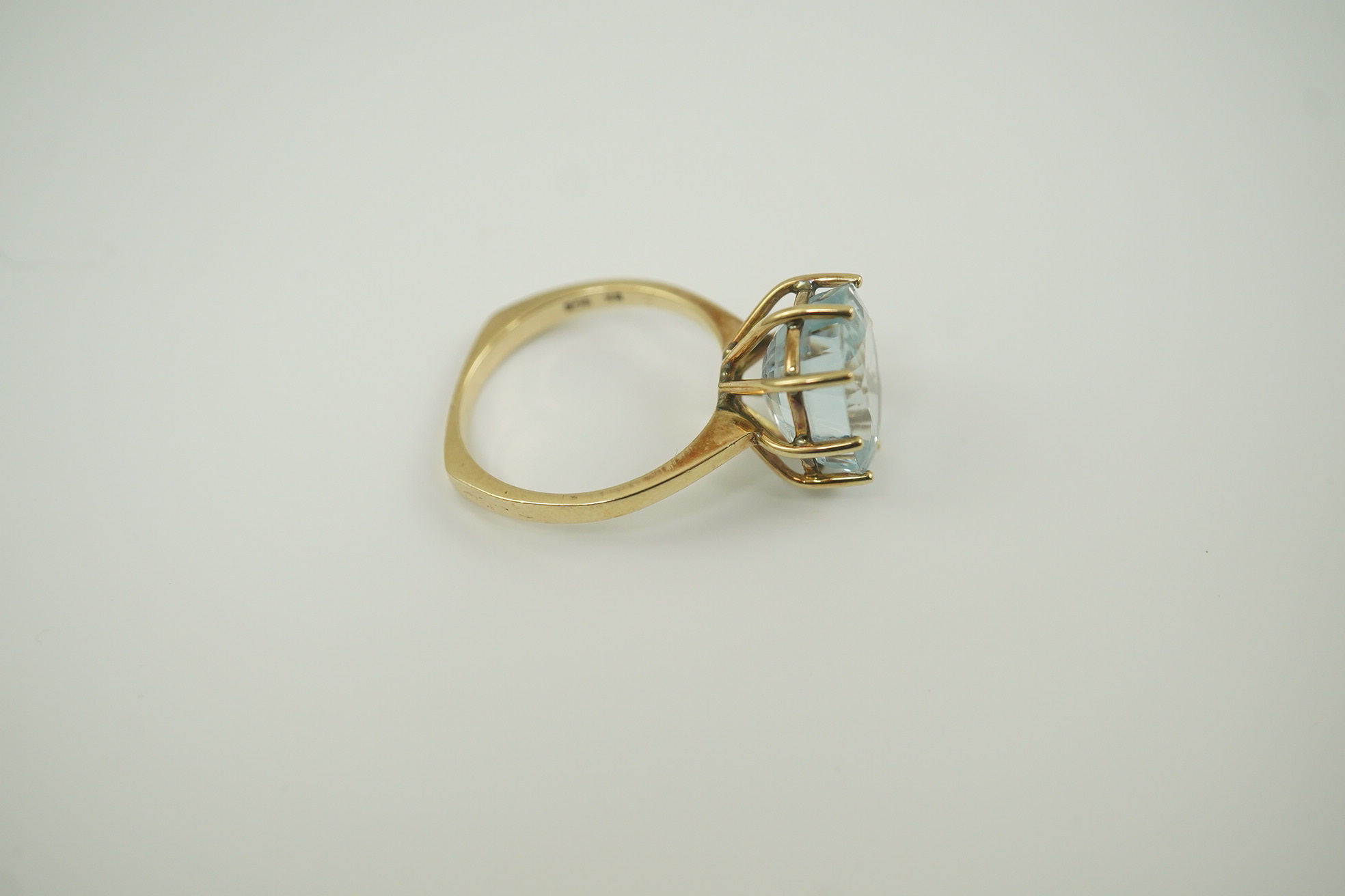 A 1970's 9ct gold and single stone oval cut aquamarine set dress ring